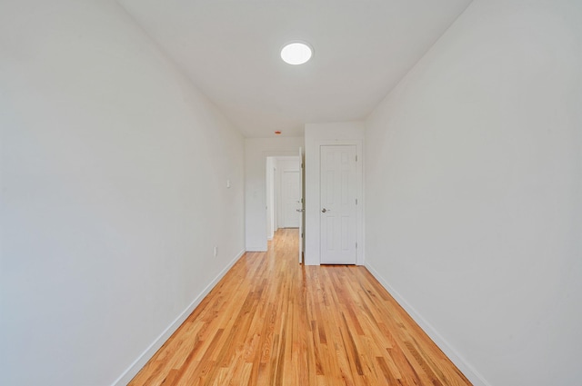 11708A 233rd St, Cambria Heights, NY 11411 - corridor featuring baseboards and light wood finished floors
