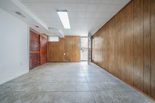 11708A 233rd St, Cambria Heights, NY 11411 - empty room featuring wooden walls and baseboards