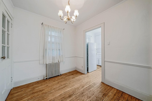 18803 Ilion Ave, Saint Albans, NY 11412 - spare room with radiator, a chandelier, wood finished floors, and crown molding