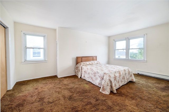 10 Wilton St, New Hyde Park, NY 11040 - carpeted bedroom featuring a baseboard radiator and baseboards
