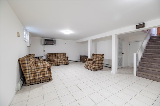 10 Wilton St, New Hyde Park, NY 11040 - living room with a wall mounted AC, a baseboard radiator, stairway, and light tile patterned floors