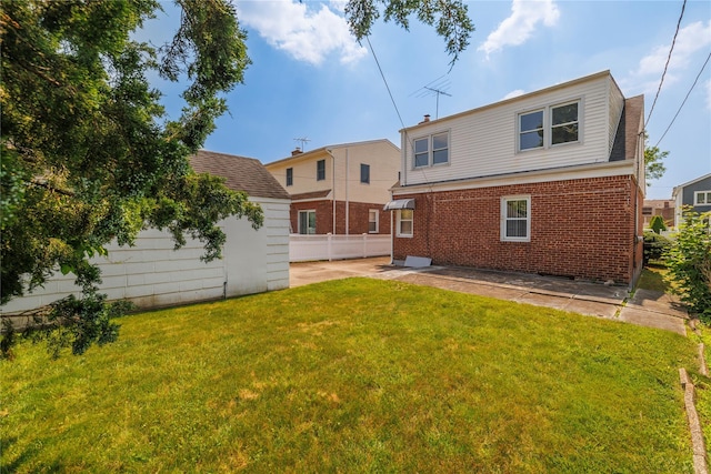 10 Wilton St, New Hyde Park, NY 11040 - back of property featuring a patio area, brick siding, and an outdoor structure