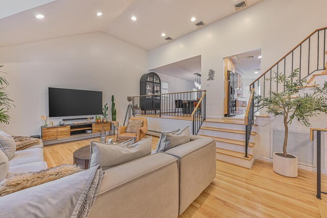 1096 Pearl St, North Woodmere, NY 11581 - living area with light wood-style flooring, vaulted ceiling, recessed lighting, and stairway