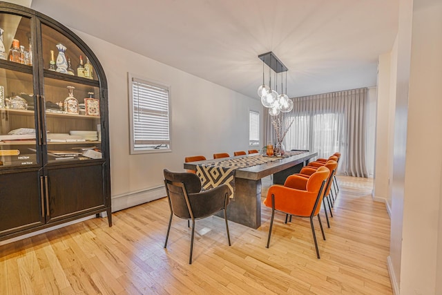 1096 Pearl St, North Woodmere, NY 11581 - dining space with light wood-style floors and a baseboard radiator