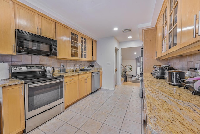 1096 Pearl St, North Woodmere, NY 11581 - kitchen featuring appliances with stainless steel finishes, light tile patterned floors, decorative backsplash, glass insert cabinets, and recessed lighting