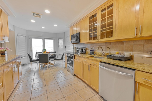 1096 Pearl St, North Woodmere, NY 11581 - kitchen with appliances with stainless steel finishes, tasteful backsplash, recessed lighting, glass insert cabinets, and light stone countertops