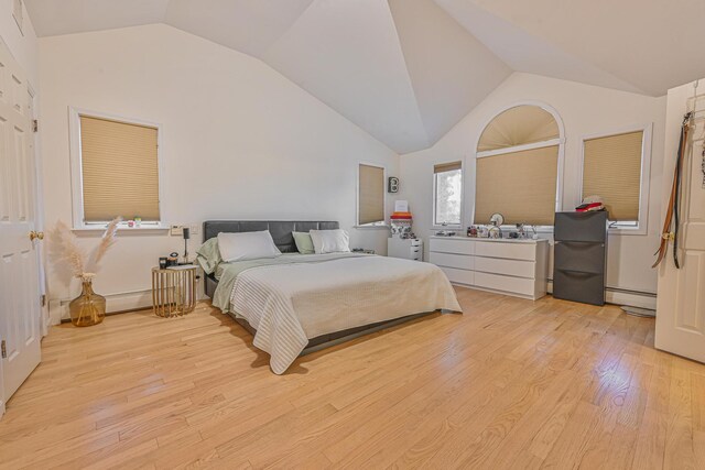 1096 Pearl St, North Woodmere, NY 11581 - bedroom featuring vaulted ceiling, light wood-type flooring, and a baseboard heating unit