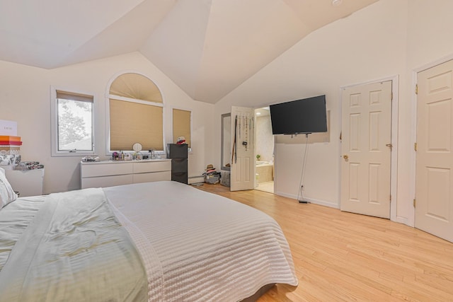 1096 Pearl St, North Woodmere, NY 11581 - bedroom featuring light wood finished floors, vaulted ceiling, and connected bathroom