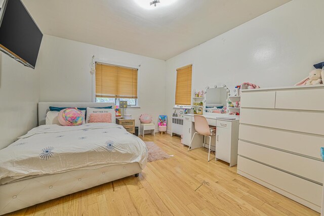 1096 Pearl St, North Woodmere, NY 11581 - bedroom featuring radiator, light wood-style floors, and an office area