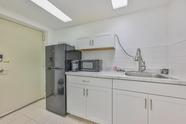 1096 Pearl St, North Woodmere, NY 11581 - kitchen featuring black appliances, white cabinetry, light tile patterned floors, and backsplash