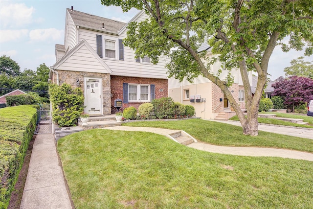 163 15th Dr, Whitestone, NY 11357 - view of front of house with a front yard, brick siding, and entry steps