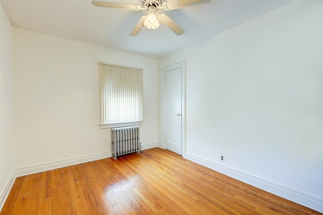 163 15th Dr, Whitestone, NY 11357 - empty room with radiator heating unit, light wood finished floors, and a ceiling fan