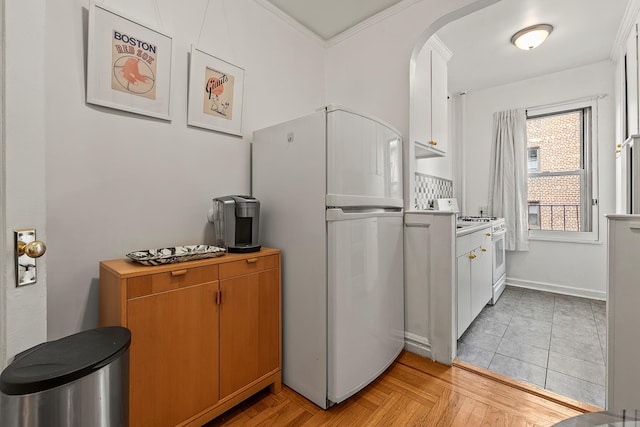 601 Pelham Pkwy N Unit 516, Bronx, NY 10467 - kitchen featuring white appliances, arched walkways, light countertops, and crown molding