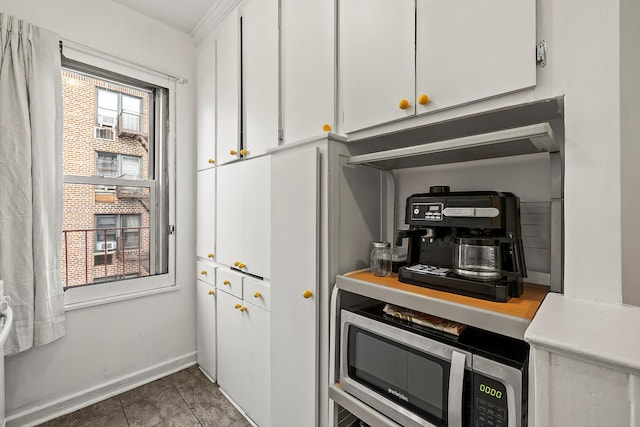 601 Pelham Pkwy N Unit 516, Bronx, NY 10467 - kitchen with white cabinets, stainless steel microwave, and light countertops