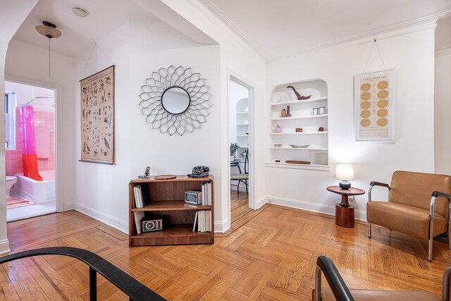 601 Pelham Pkwy N Unit 516, Bronx, NY 10467 - living area featuring built in shelves and crown molding