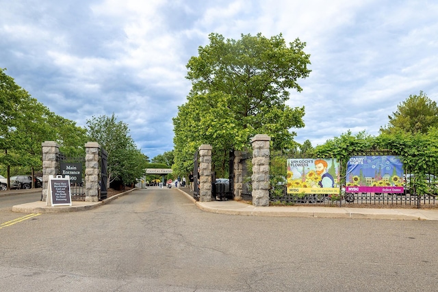 601 Pelham Pkwy N Unit 516, Bronx, NY 10467 - view of asphalt street featuring curbs, a gated entry, and sidewalks