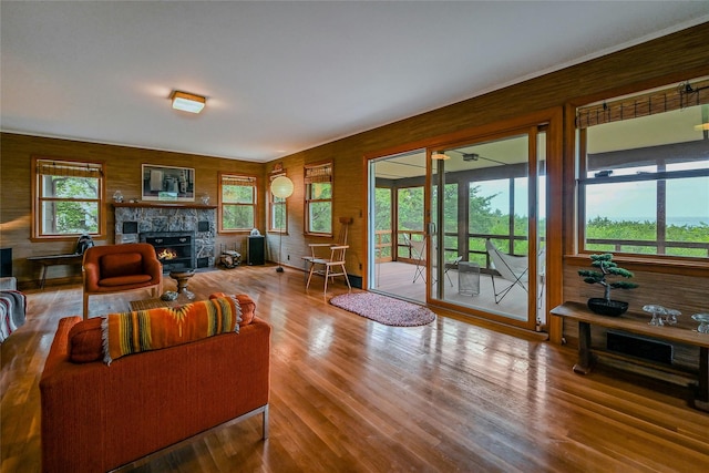 103 Harbor Beach Rd, Miller Place, NY 11764 - living room featuring a fireplace, wood finished floors, and wooden walls