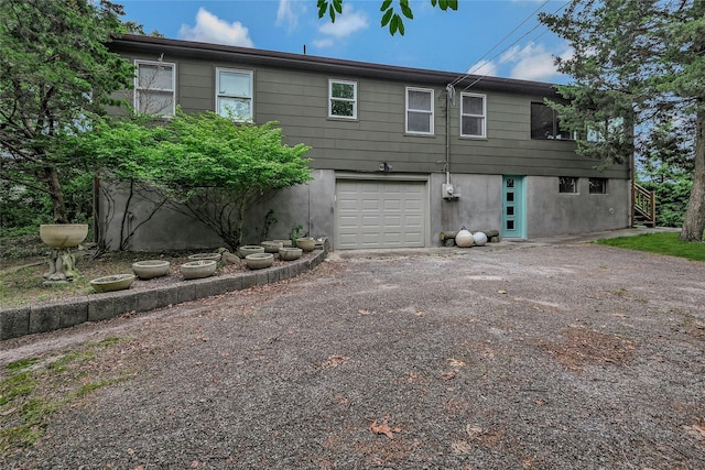 103 Harbor Beach Rd, Miller Place, NY 11764 - rear view of property with an attached garage and driveway