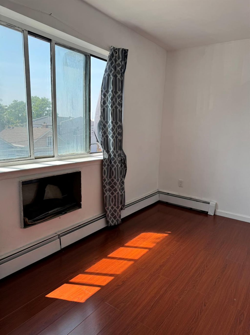 1811 123rd St Unit 4F, College Point, NY 11356 - unfurnished room featuring wood finished floors and baseboards