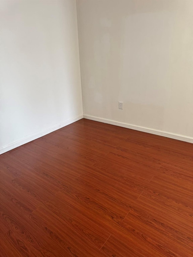 1811 123rd St Unit 4F, College Point, NY 11356 - empty room with dark wood finished floors and baseboards