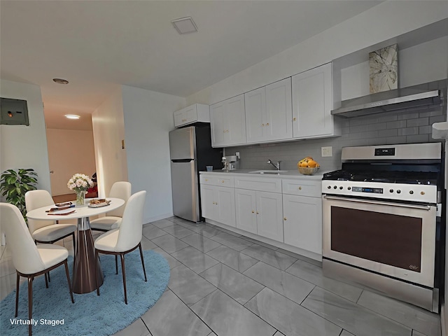 1811 123rd St Unit 4F, College Point, NY 11356 - kitchen featuring stainless steel appliances, decorative backsplash, white cabinetry, and light countertops