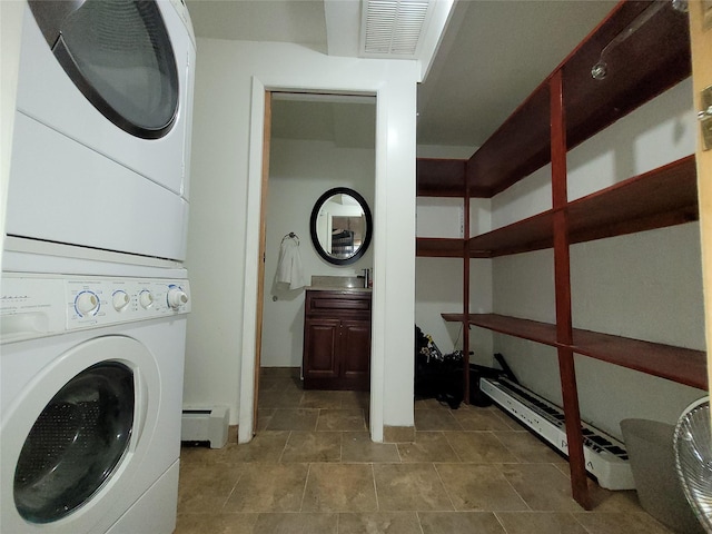 240-02 70th Ave Unit 1C, Douglaston, NY 11362 - laundry area featuring stacked washer / drying machine and baseboard heating