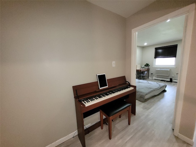 240-02 70th Ave Unit 1C, Douglaston, NY 11362 - sitting room featuring light wood-type flooring, a wall unit AC, recessed lighting, and a baseboard heating unit