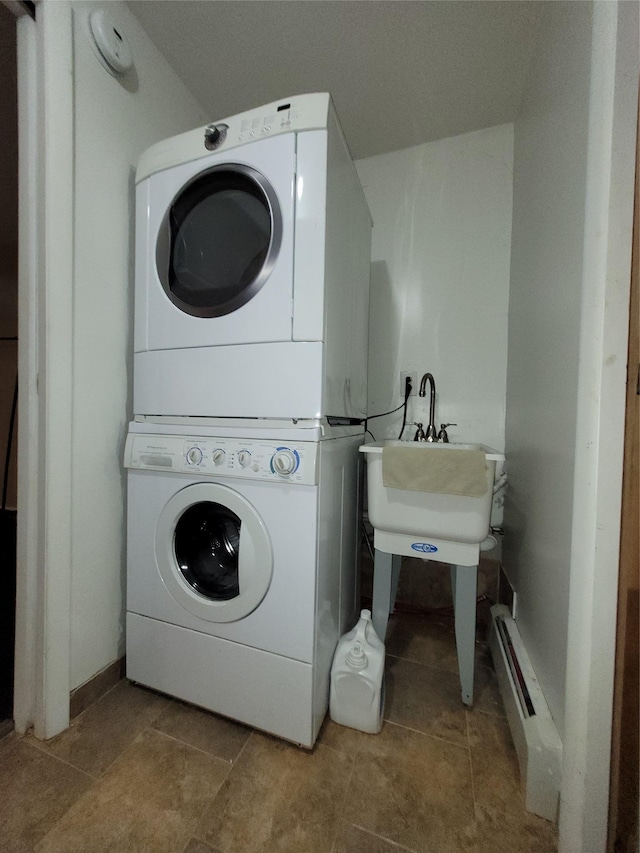 240-02 70th Ave Unit 1C, Douglaston, NY 11362 - washroom featuring stacked washer and clothes dryer, a baseboard heating unit, and tile patterned flooring