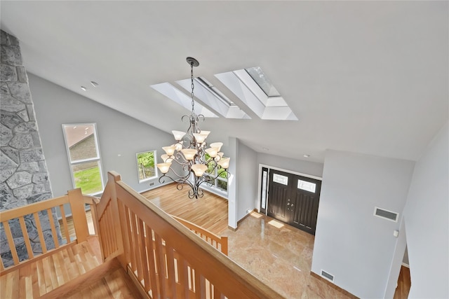 94 Hirst Rd, Briarcliff Manor, NY 10510 - entrance foyer featuring a skylight, a chandelier, vaulted ceiling, and wood finished floors