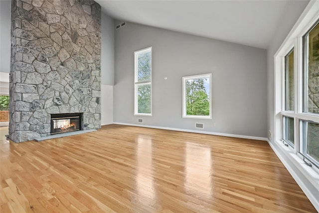 94 Hirst Rd, Briarcliff Manor, NY 10510 - unfurnished living room with healthy amount of natural light, wood finished floors, high vaulted ceiling, and a fireplace