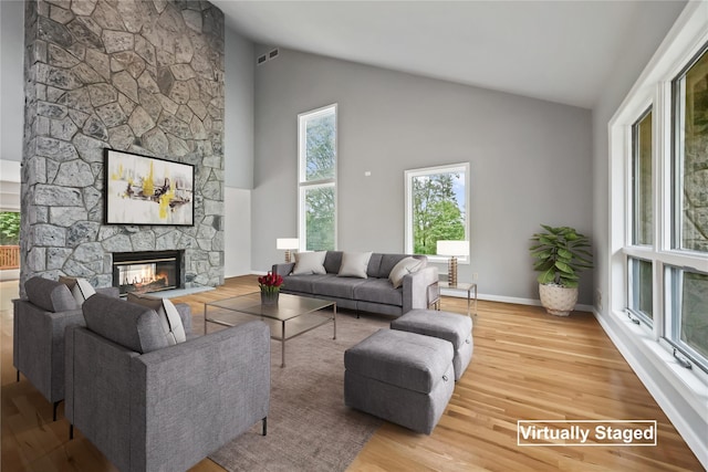 94 Hirst Rd, Briarcliff Manor, NY 10510 - living area featuring a stone fireplace, wood finished floors, and high vaulted ceiling