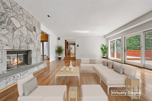 94 Hirst Rd, Briarcliff Manor, NY 10510 - living room featuring a stone fireplace and wood finished floors