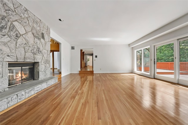 94 Hirst Rd, Briarcliff Manor, NY 10510 - unfurnished living room with wood finished floors and a stone fireplace
