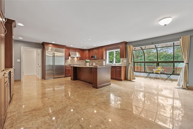 94 Hirst Rd, Briarcliff Manor, NY 10510 - kitchen with stainless steel appliances, ventilation hood, light countertops, backsplash, and a center island