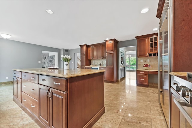 94 Hirst Rd, Briarcliff Manor, NY 10510 - kitchen with tasteful backsplash, a kitchen island, recessed lighting, light stone countertops, and wine cooler