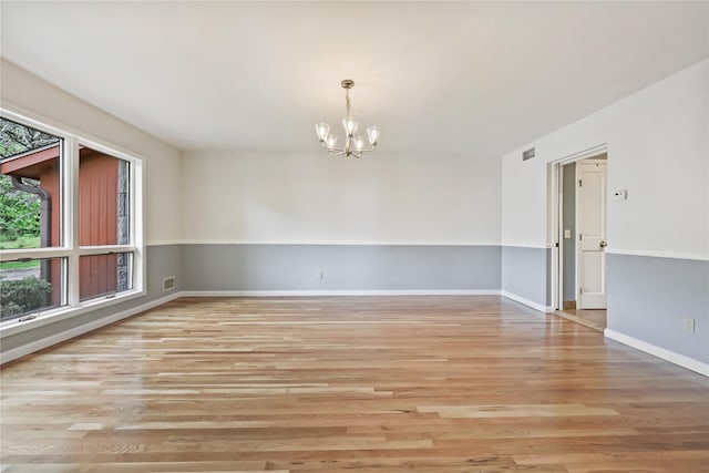 94 Hirst Rd, Briarcliff Manor, NY 10510 - unfurnished room featuring a chandelier and wood finished floors