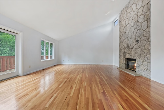 94 Hirst Rd, Briarcliff Manor, NY 10510 - unfurnished living room with vaulted ceiling, light wood finished floors, and a stone fireplace