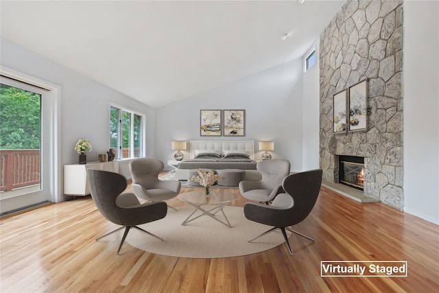 94 Hirst Rd, Briarcliff Manor, NY 10510 - living area with lofted ceiling, healthy amount of natural light, a stone fireplace, and wood finished floors