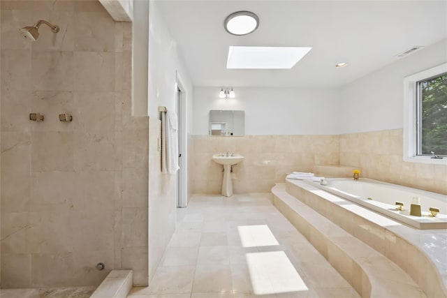 94 Hirst Rd, Briarcliff Manor, NY 10510 - bathroom with tile walls, a skylight, a bath, tiled shower, and tile patterned flooring