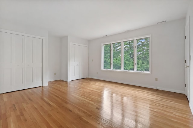 94 Hirst Rd, Briarcliff Manor, NY 10510 - unfurnished bedroom with two closets and light wood-type flooring