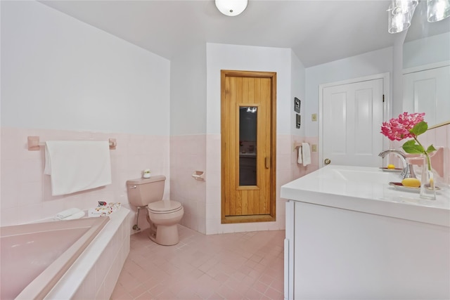 94 Hirst Rd, Briarcliff Manor, NY 10510 - bathroom with vanity, tile walls, a relaxing tiled tub, wainscoting, and tile patterned flooring