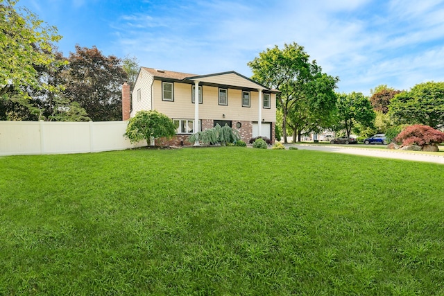 27 Dorchester Rd, Smithtown, NY 11787 - view of front of house featuring a garage, brick siding, concrete driveway, and a chimney