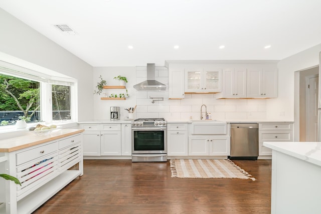 27 Dorchester Rd, Smithtown, NY 11787 - kitchen with appliances with stainless steel finishes, wall chimney exhaust hood, open shelves, light countertops, and backsplash