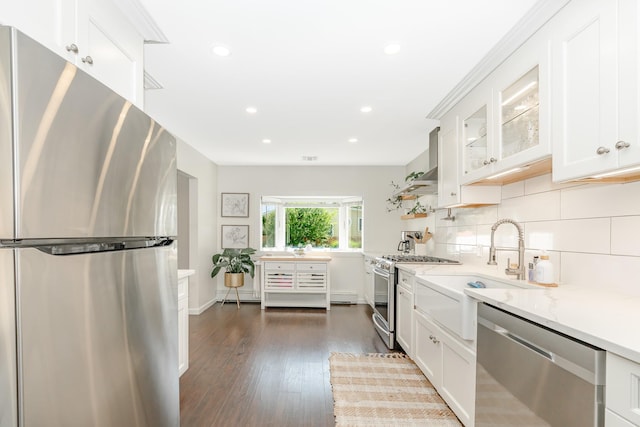 27 Dorchester Rd, Smithtown, NY 11787 - kitchen featuring stainless steel appliances, light stone counters, recessed lighting, dark wood-style flooring, and white cabinetry