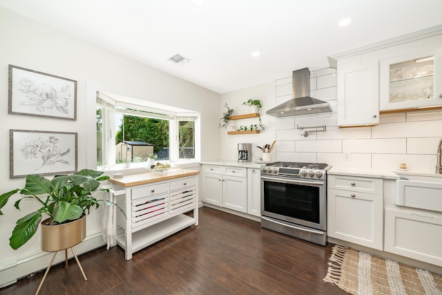 27 Dorchester Rd, Smithtown, NY 11787 - kitchen with stainless steel gas stove, wall chimney exhaust hood, light countertops, tasteful backsplash, and white cabinets