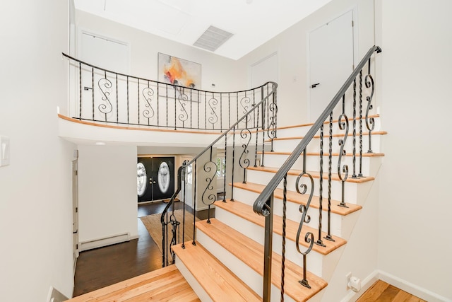 27 Dorchester Rd, Smithtown, NY 11787 - stairs with baseboard heating and wood finished floors