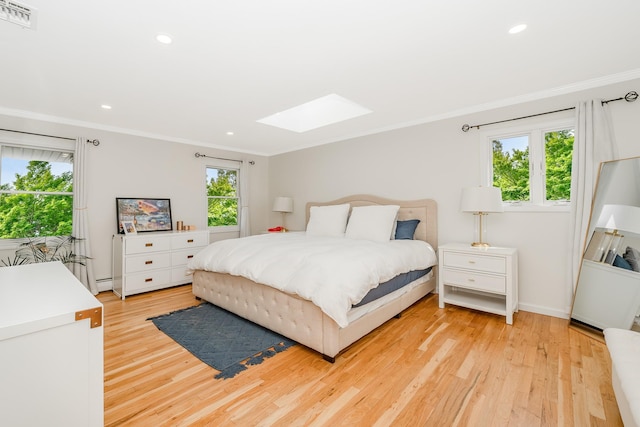 27 Dorchester Rd, Smithtown, NY 11787 - bedroom with a skylight, crown molding, light wood-style floors, recessed lighting, and baseboard heating