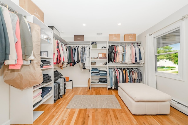 27 Dorchester Rd, Smithtown, NY 11787 - walk in closet featuring a baseboard heating unit and wood finished floors