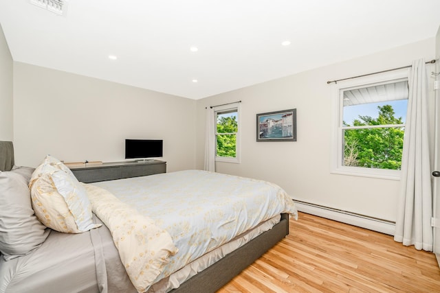 27 Dorchester Rd, Smithtown, NY 11787 - bedroom featuring a baseboard heating unit, light wood finished floors, and recessed lighting