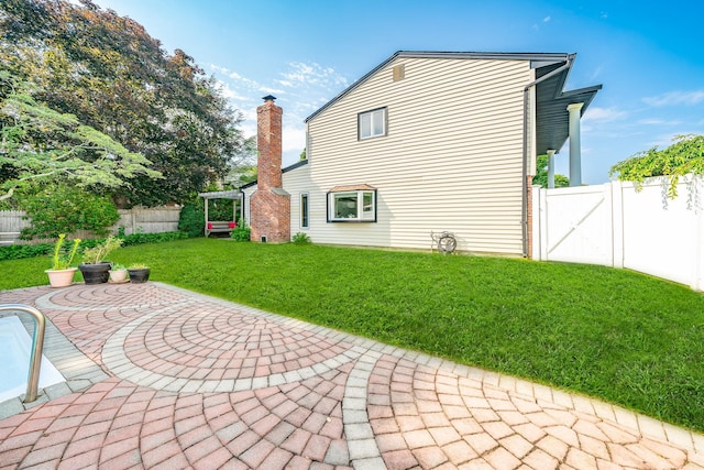 27 Dorchester Rd, Smithtown, NY 11787 - rear view of property featuring a patio, a fenced backyard, a gate, a pergola, and a chimney